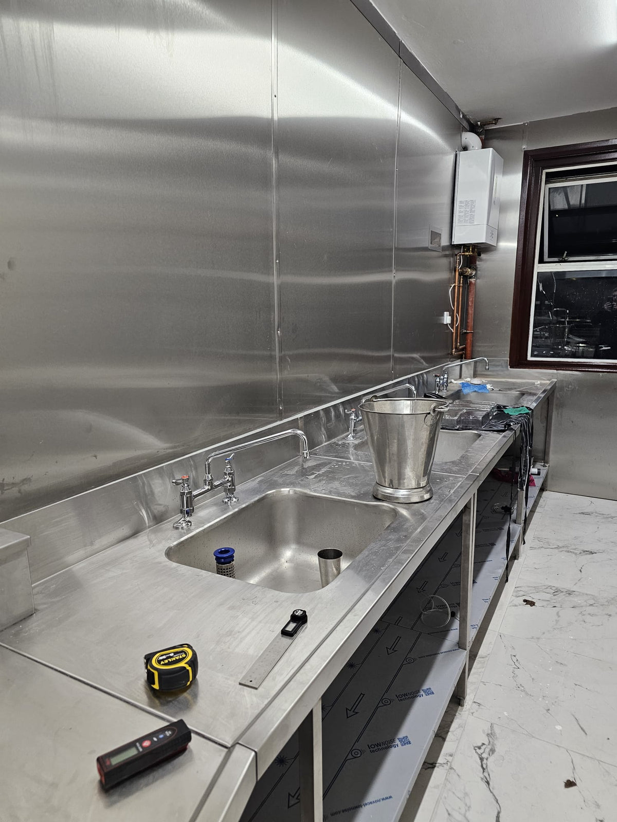 Installed stainless steel sink bench and splashback