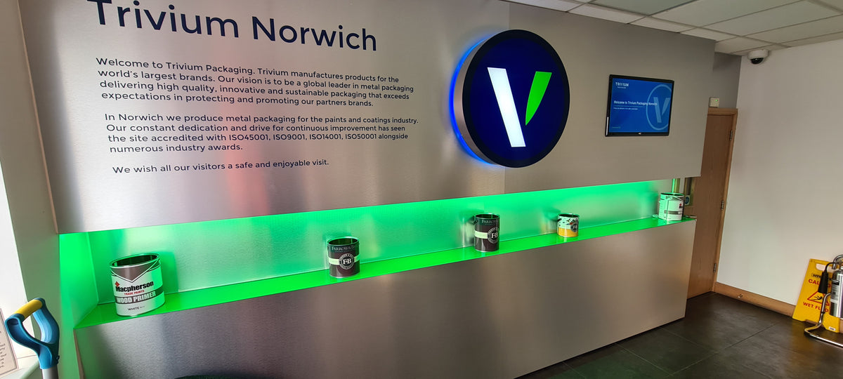 Illuminated green reception feature with lettering and a fitted shelf