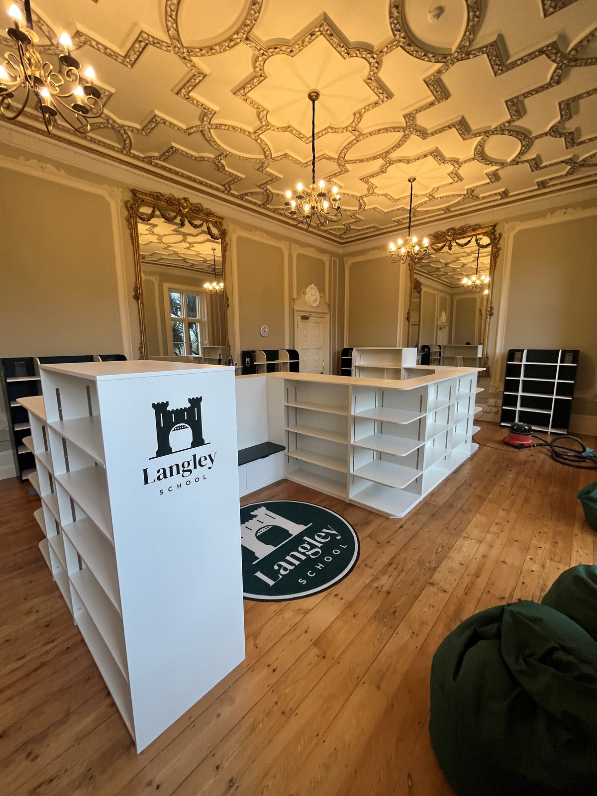 Freestanding library shelving with printed end panels in a finished interior